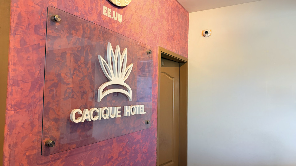 Cacique Hotel logo on the lobby wall, next to the lift