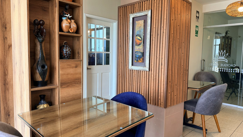 Detail of the restaurant dining room, with a display cabinet of decorative pottery