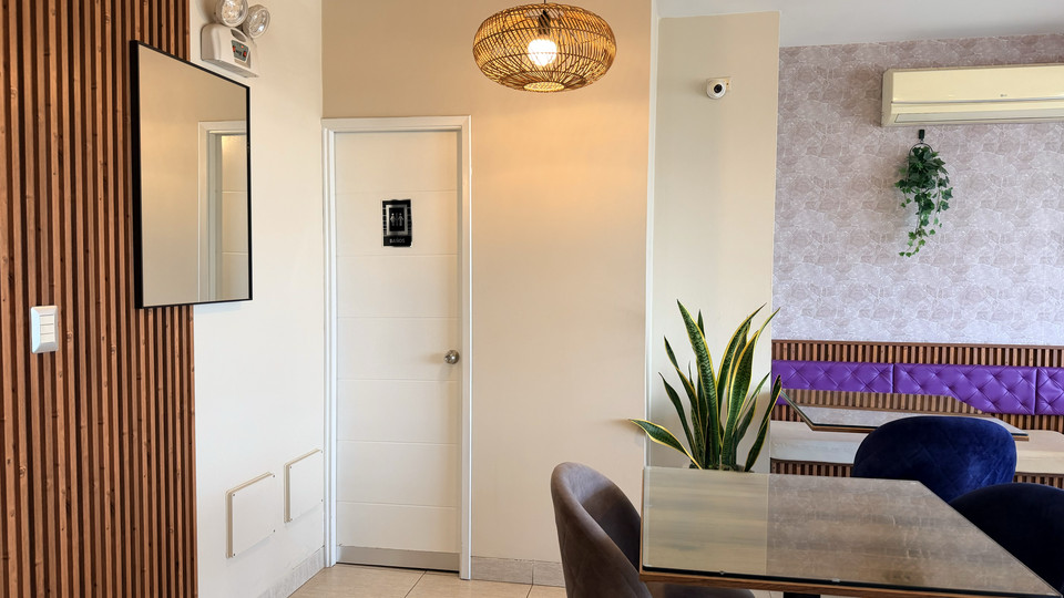 Restaurant setting with air conditioning and purple-toned decor