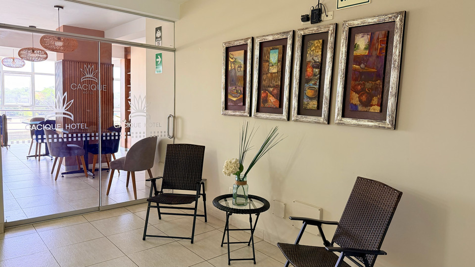 Terrace with tables and chairs next to the Cacique Hotel coffee shop