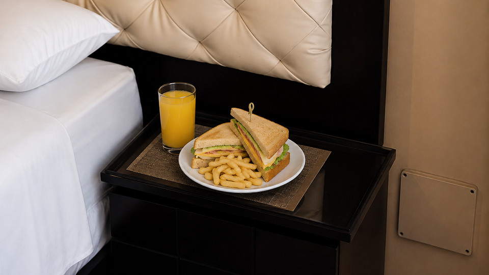 Sandwich, fries and juice served in the room at Cacique Hotel